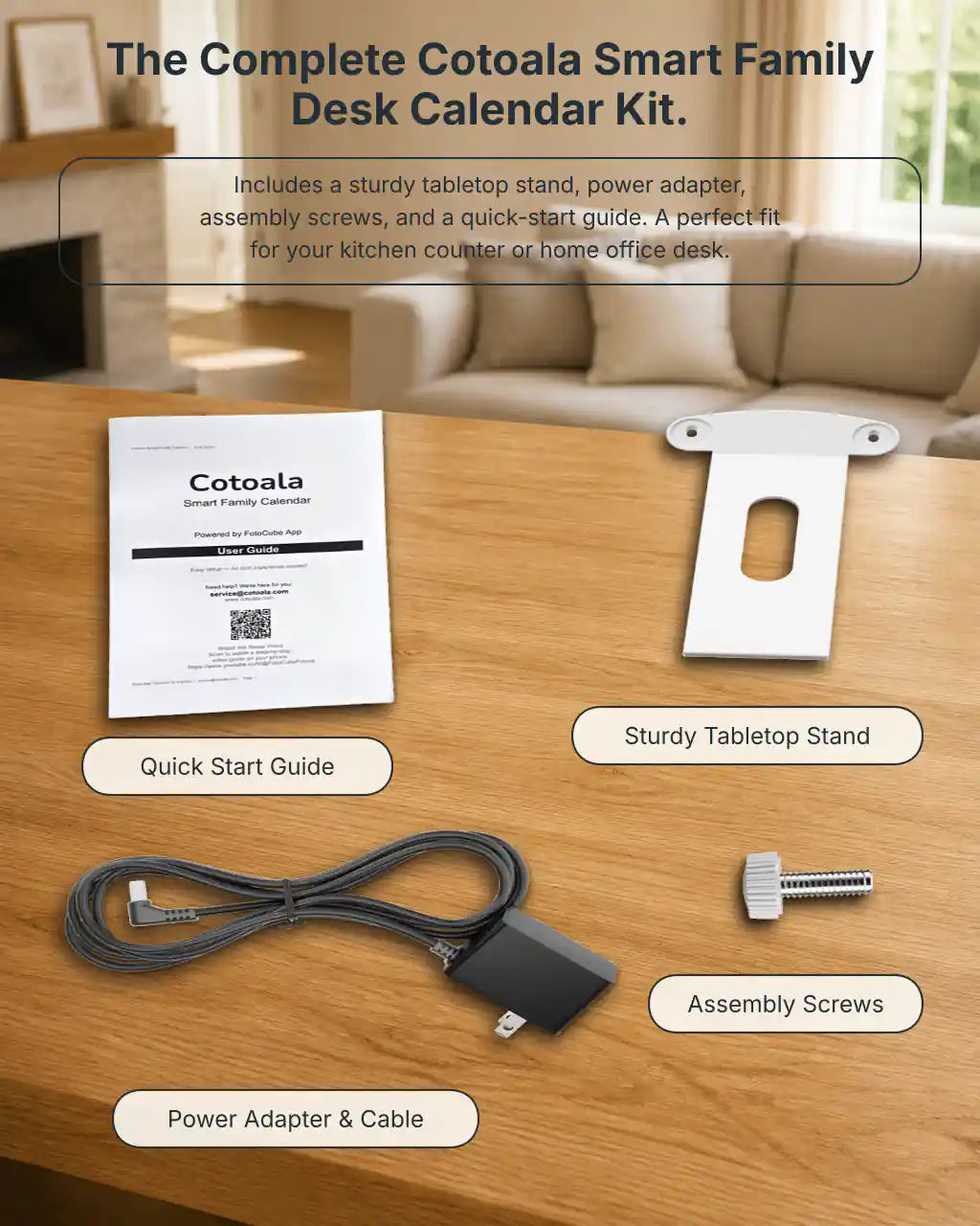 Cotoala smart family desk calendar kit with a quick-start guide, white tabletop stand, power adapter and cable, and assembly screw arranged on a wooden table in a warm American living room.