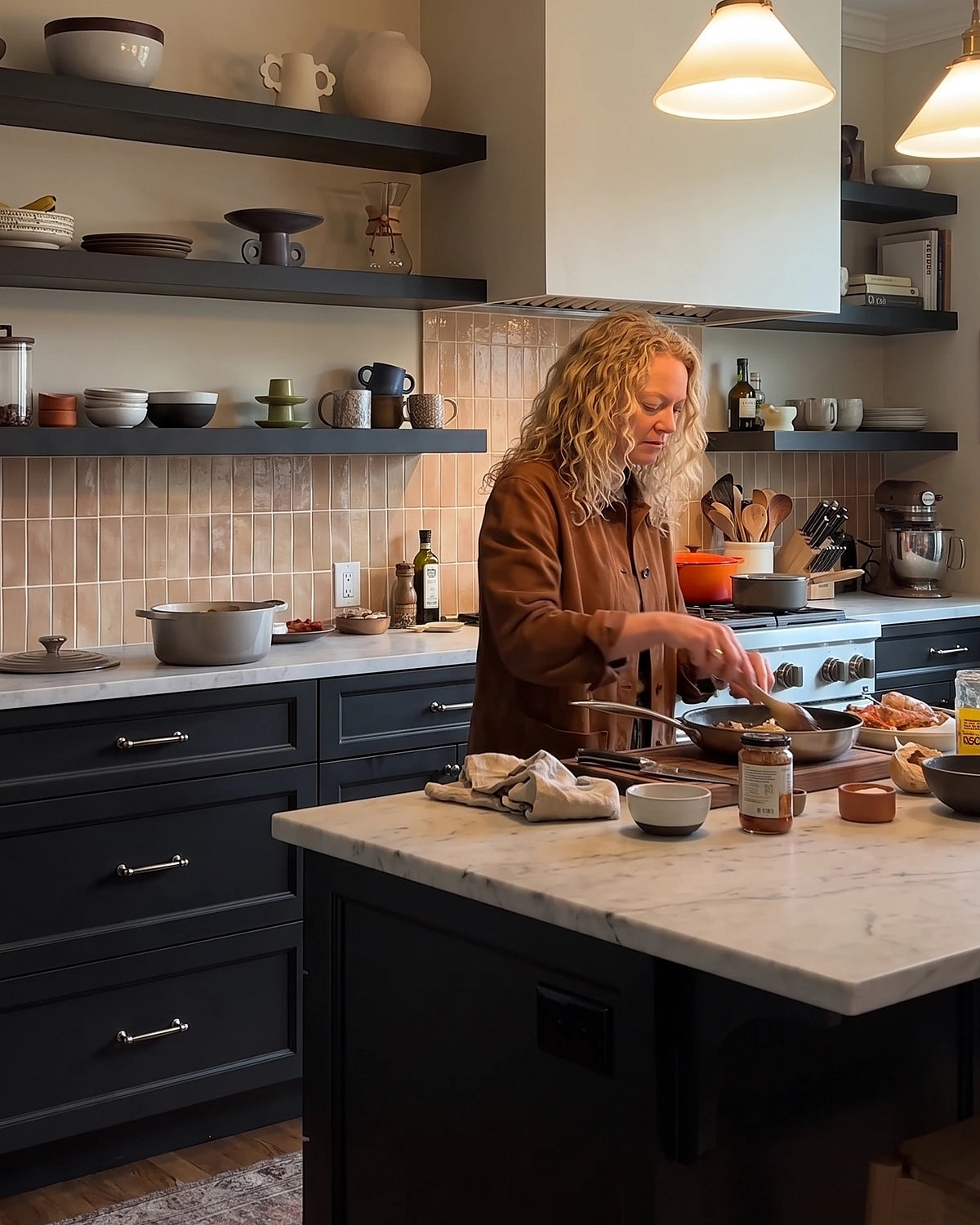 Woman cooking a meal at the island in a modern home kitchen